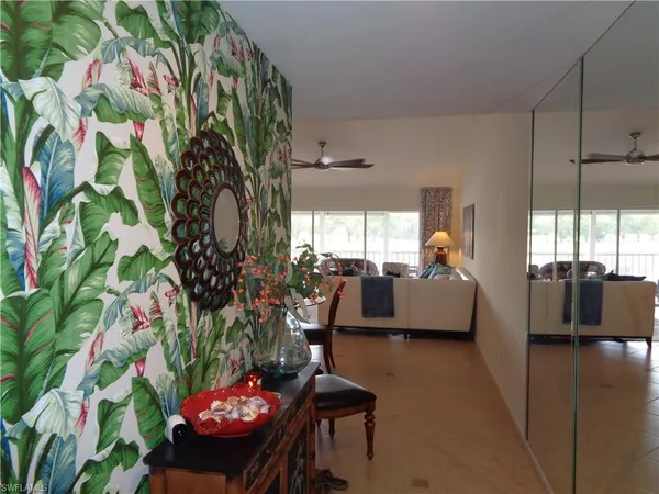 a living room with furniture and flowers