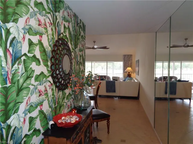 a living room with furniture and flowers