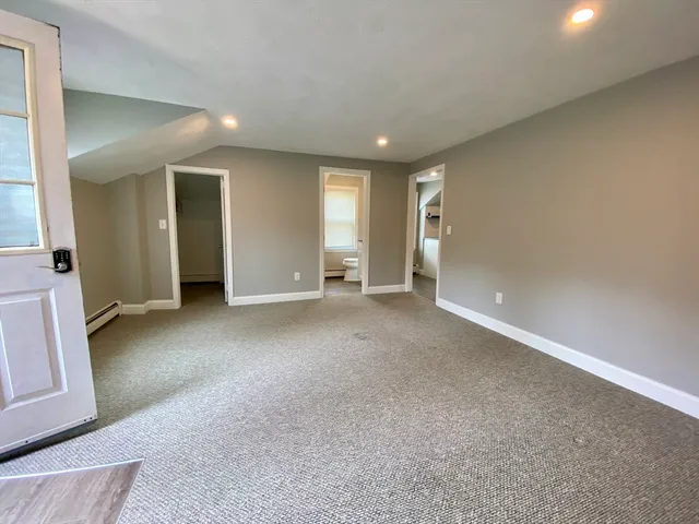 an empty room with windows and pillars in it