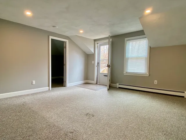 an empty room with windows and closet