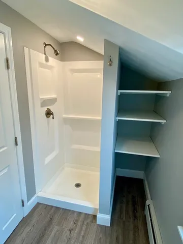 a bathroom with a glass shower door and a tub