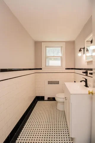 a bathroom with a sink a toilet and a mirror