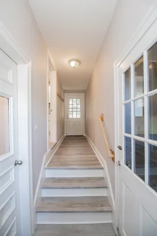a view of staircase with white walls and windows