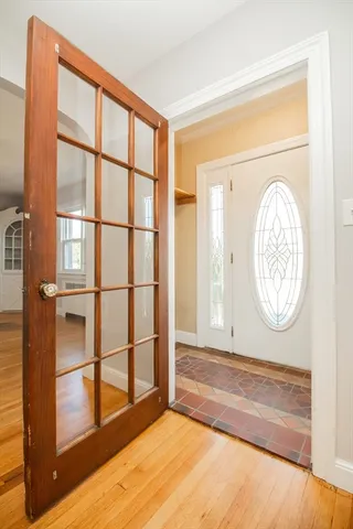 a view of a room with wooden floor and a window