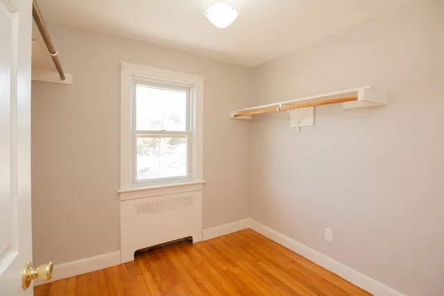 a view of a room with wooden floor and fan