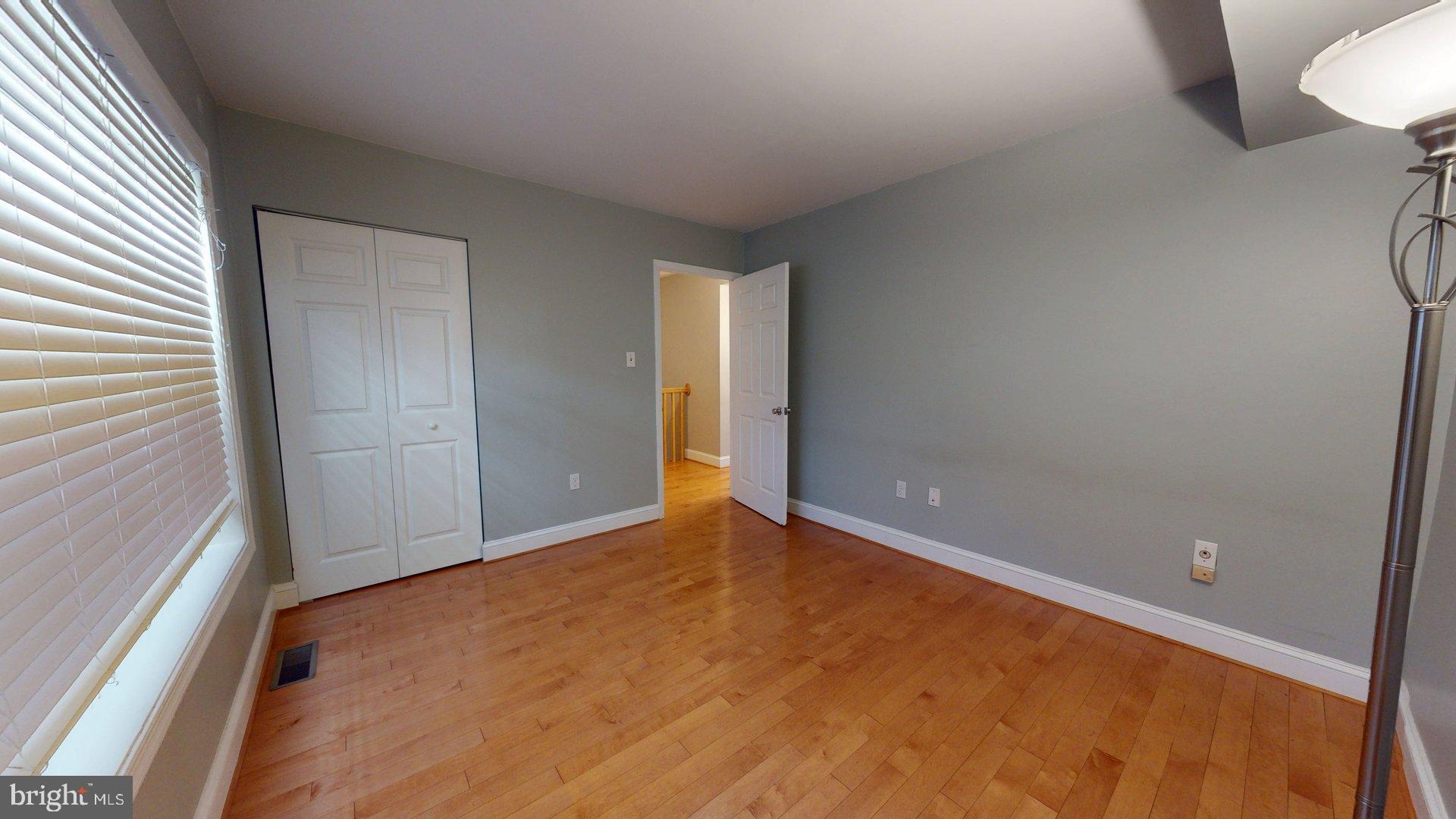 951 South Rolfe Street, Unit 1 Arlington, VA 22204 - Photo 13 of 18 a view of an empty room with wooden floor