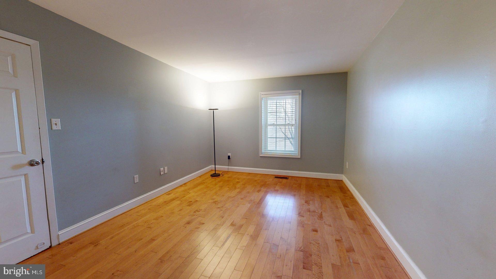 951 South Rolfe Street, Unit 1 Arlington, VA 22204 - Photo 17 of 18 a view of an empty room with window and wooden floor