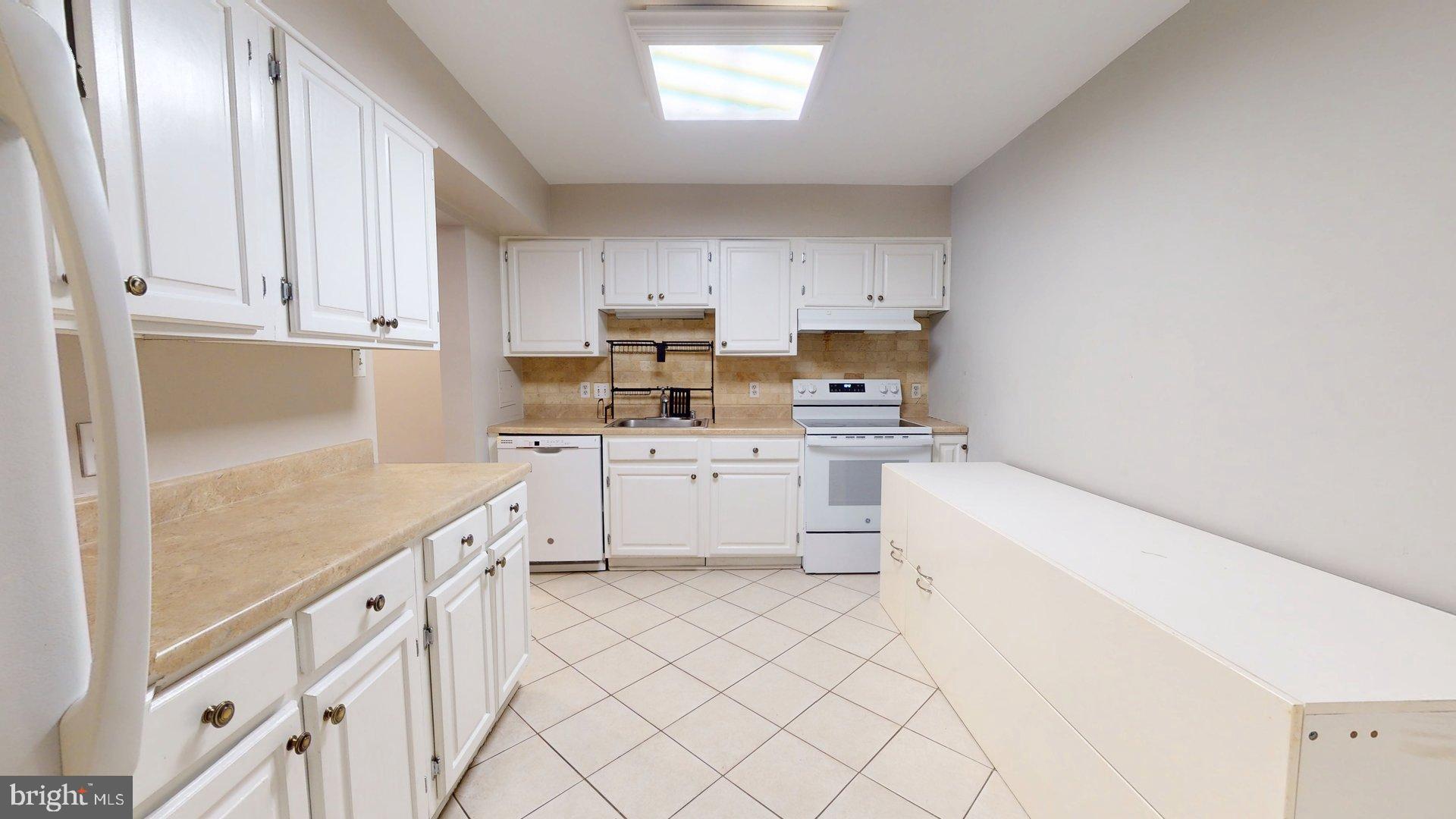 951 South Rolfe Street, Unit 1 Arlington, VA 22204 - Photo 6 of 18 a kitchen with white cabinets appliances and a window
