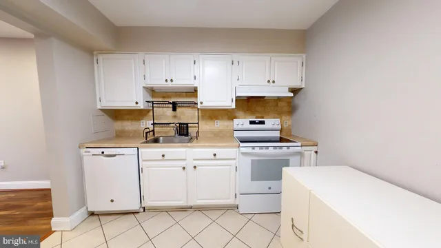 a kitchen with cabinets appliances and a sink