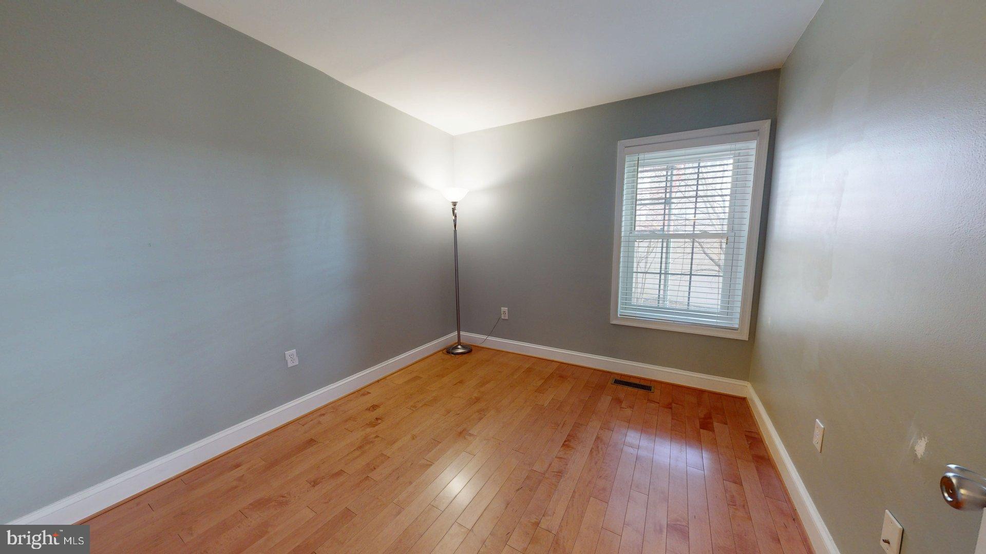 951 South Rolfe Street, Unit 1 Arlington, VA 22204 - Photo 10 of 18 an empty room with wooden floor and windows