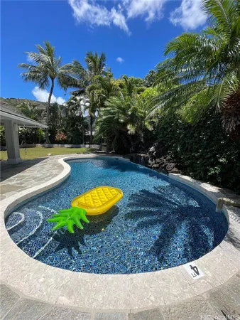 a view of a swimming pool with a yard