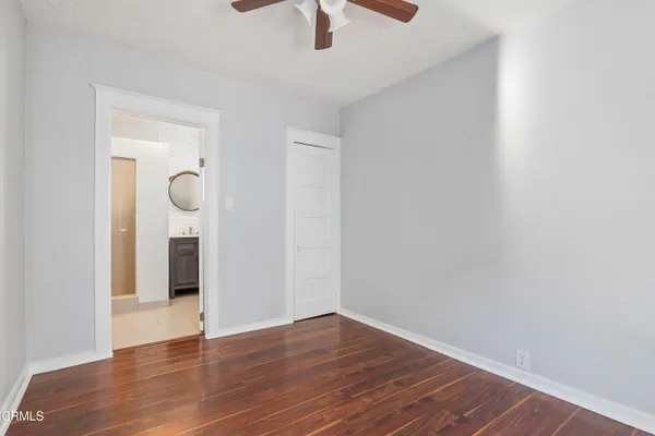 a view of an empty room with wooden floor