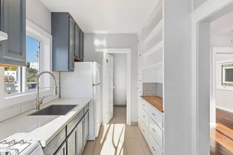 a kitchen with a sink stove and refrigerator