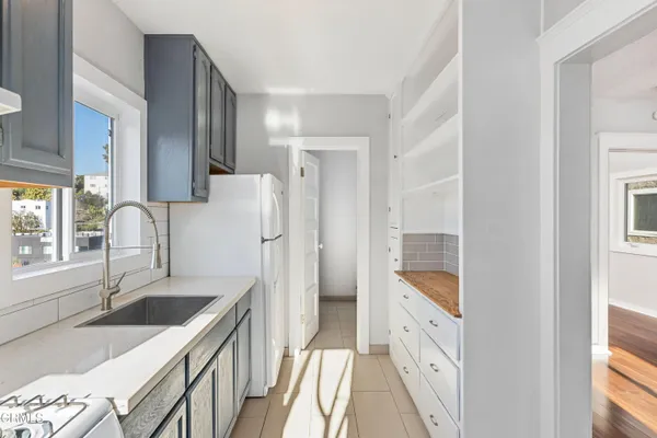 a kitchen with a sink stove and refrigerator