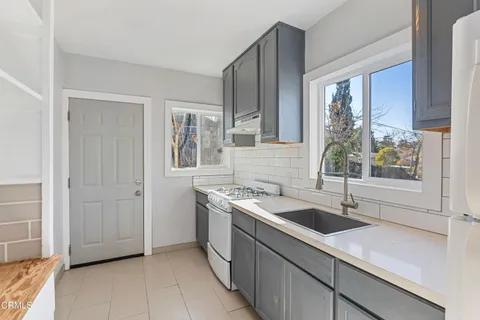 a kitchen with a sink and a stove top oven
