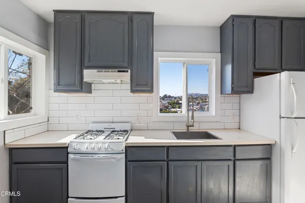 a kitchen with a sink cabinets and stainless steel appliances
