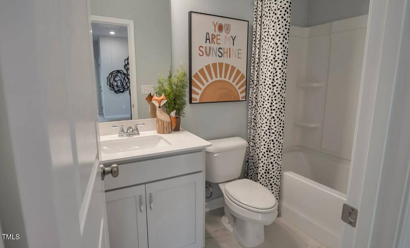 726 Orch Vista Circle Raleigh, NC 27606 - Photo 13 of 16 a bathroom with a sink mirror vanity and toilet