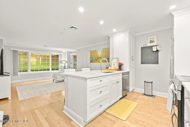 a spacious bathroom with a double vanity sink a mirror and a bathtub