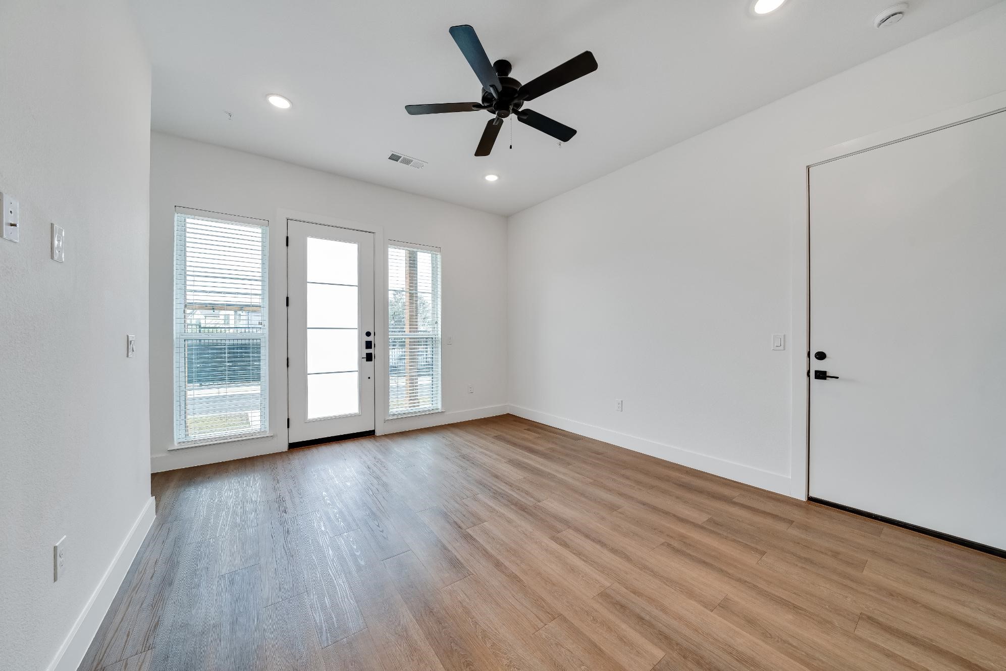 1601-121 Mustang Drive Marble Falls, TX 78654 - Photo 4 of 26 a view of an empty room with a window and wooden floor