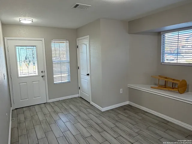 wooden floor in an empty room with a window