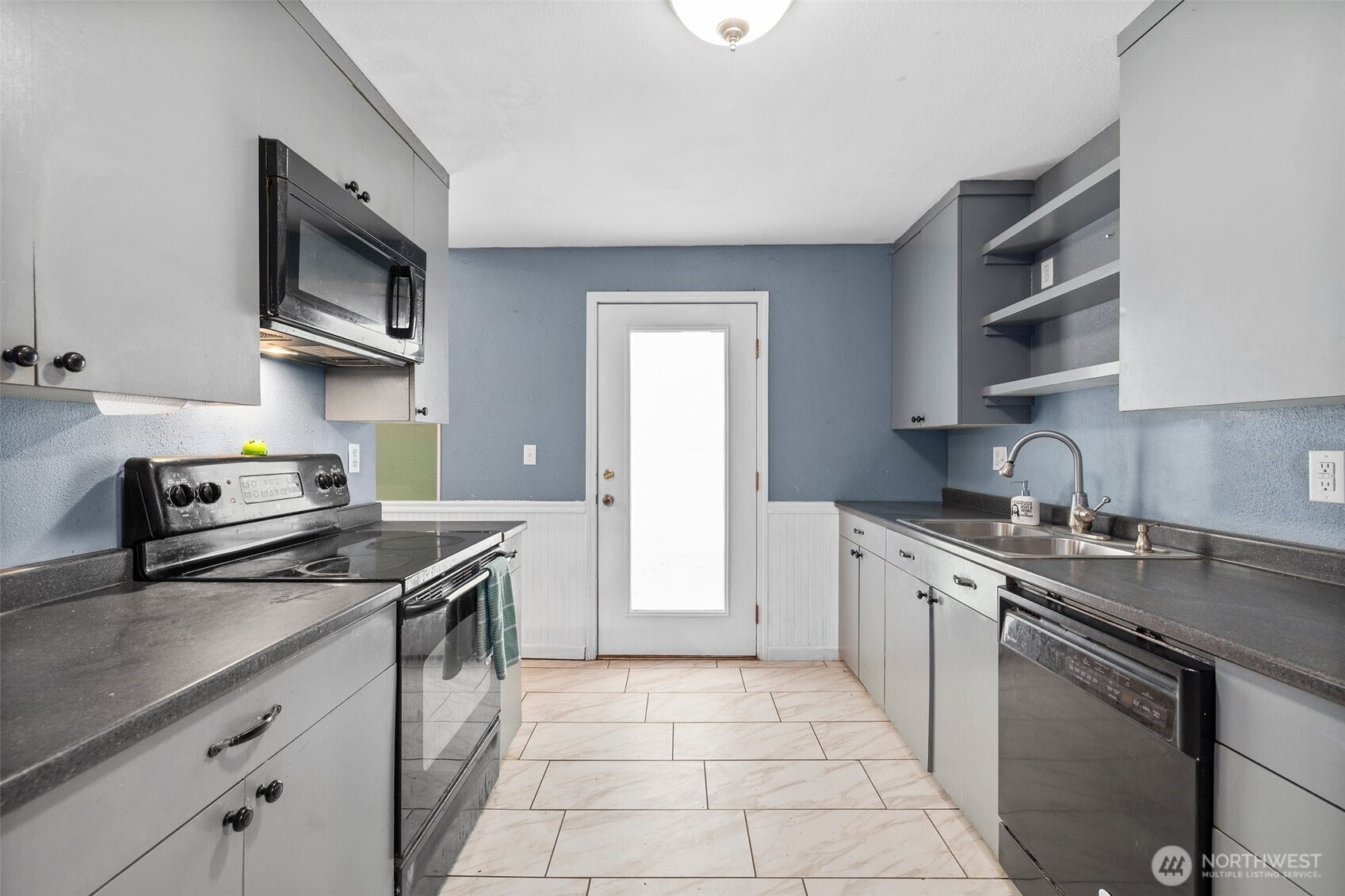 3710 Rucker Avenue Everett, WA 98201 - Photo 15 of 33 a kitchen with stainless steel appliances granite countertop a stove a sink and a microwave