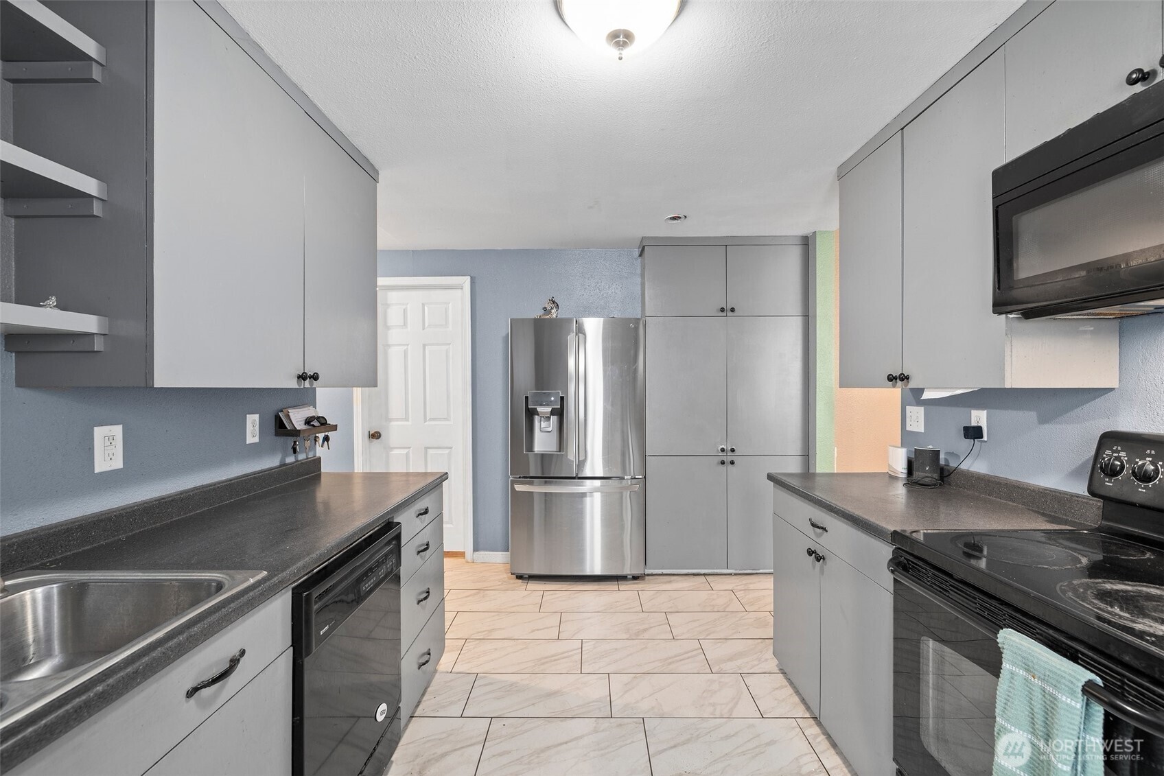 3710 Rucker Avenue Everett, WA 98201 - Photo 19 of 33 a kitchen with stainless steel appliances a sink stove and refrigerator
