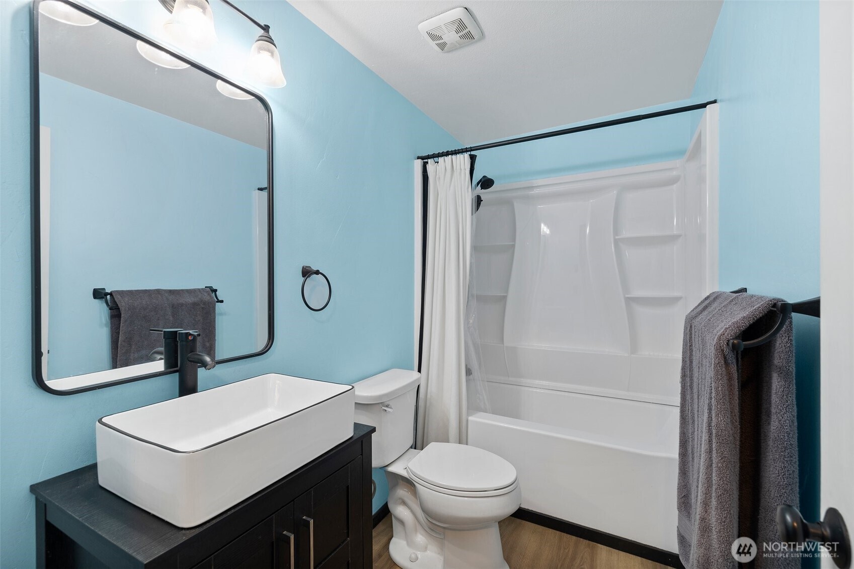 3710 Rucker Avenue Everett, WA 98201 - Photo 24 of 33 a bathroom with a toilet a sink and a mirror