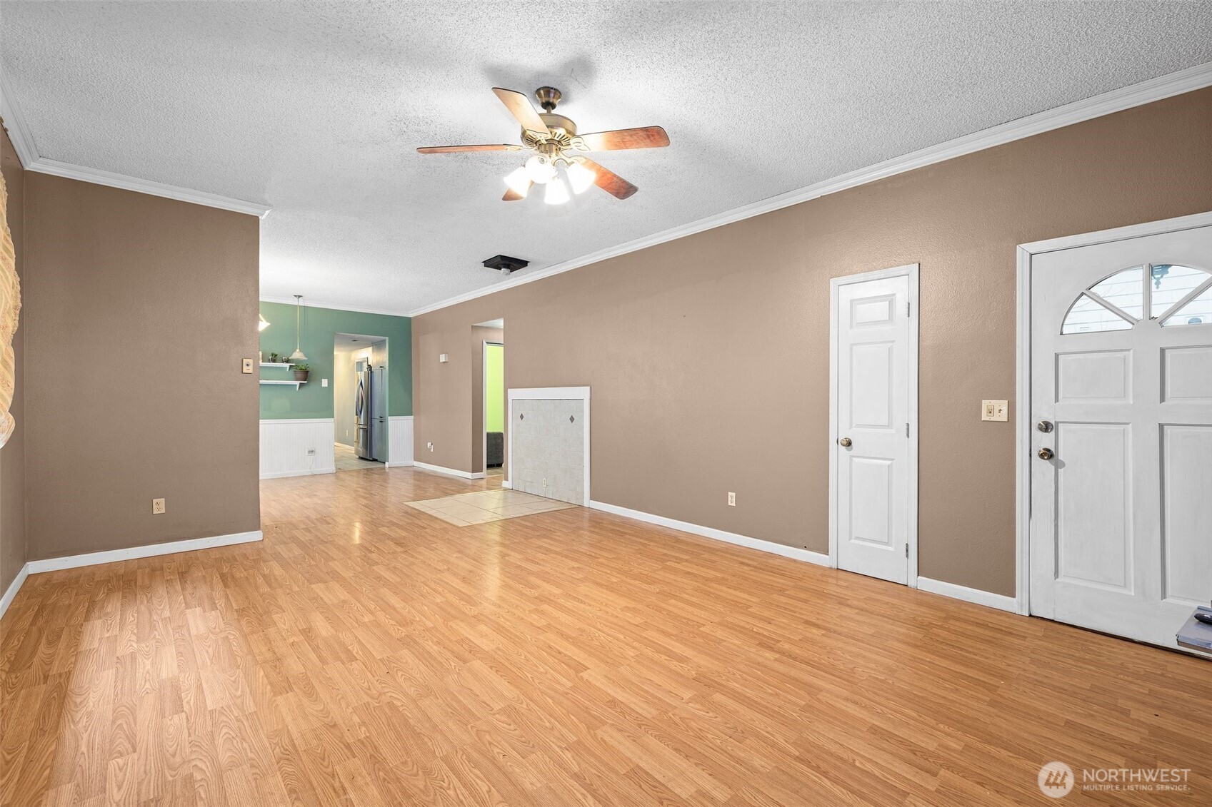 3710 Rucker Avenue Everett, WA 98201 - Photo 6 of 33 a view of an empty room with wooden floor and a ceiling fan