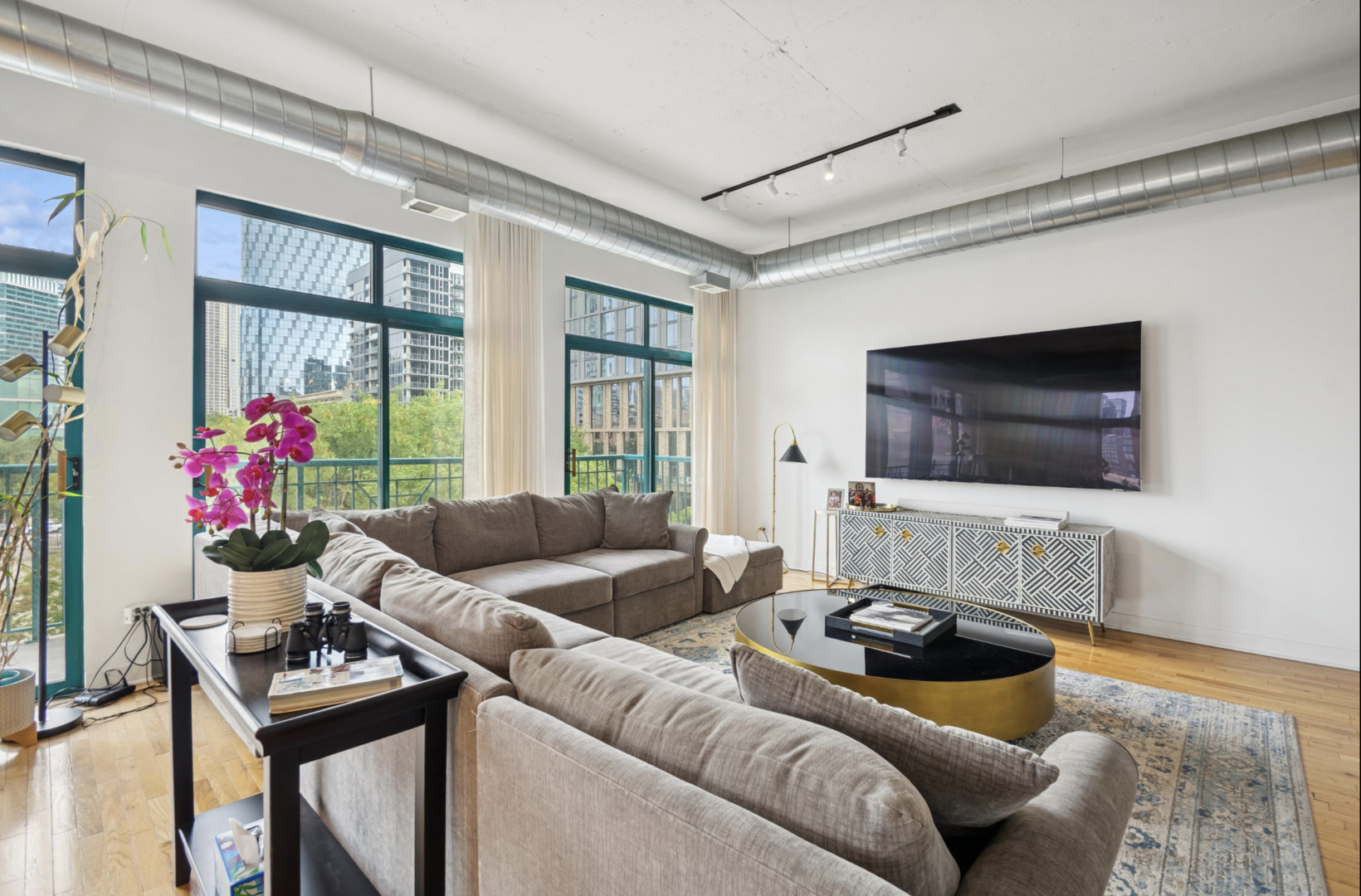 910 West Madison Street, Unit 408 Chicago, IL 60607 - Photo 7 of 16 a living room with furniture and a flat screen tv