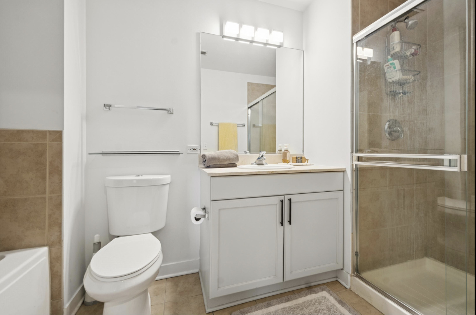 910 West Madison Street, Unit 408 Chicago, IL 60607 - Photo 10 of 16 a bathroom with a sink a toilet and shower