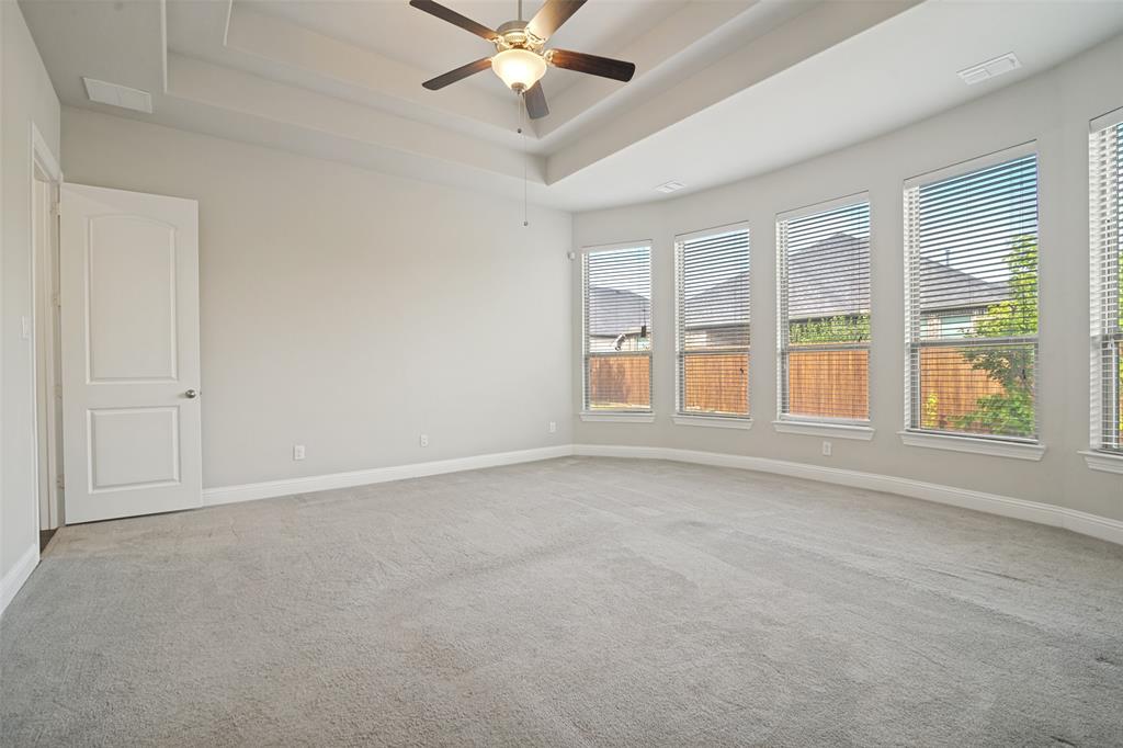 2802 Merlot Circle Rowlett, TX 75088 - Photo 16 of 40 an empty room with chandelier fan and windows