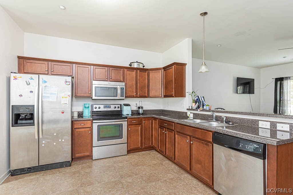 12124 Perdue Springs Loop Chester, VA 23831 - Photo 11 of 26 a kitchen with stainless steel appliances granite countertop a sink a stove a refrigerator and island