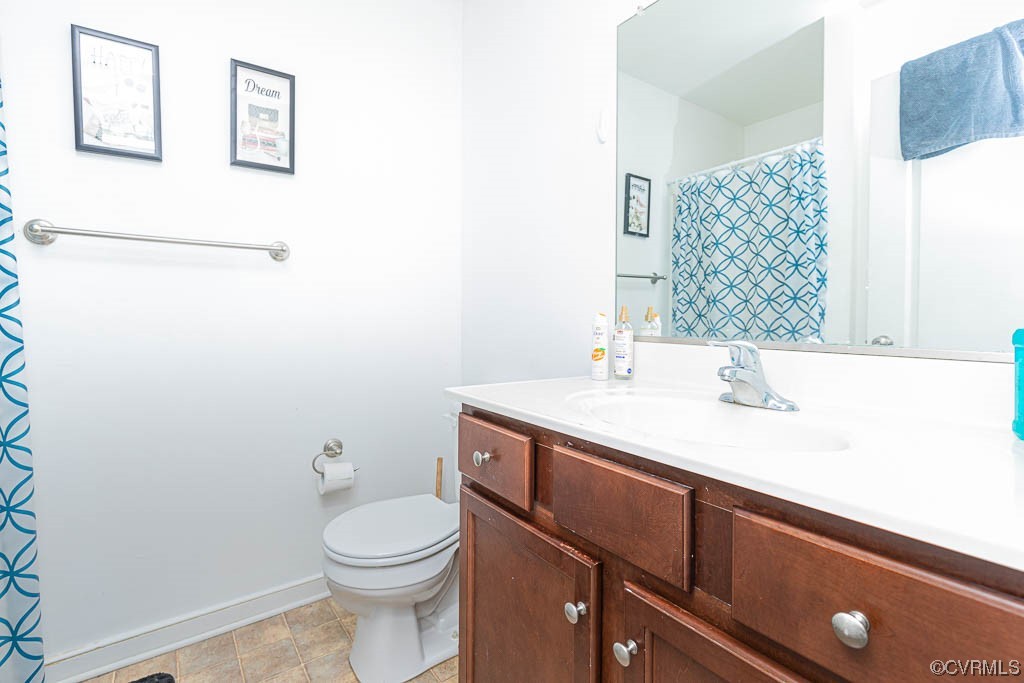 12124 Perdue Springs Loop Chester, VA 23831 - Photo 15 of 26 a bathroom with a sink a toilet and mirror
