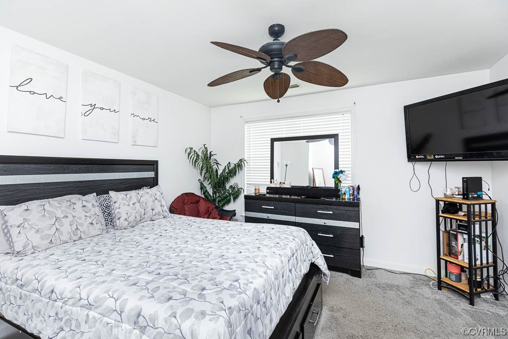 12124 Perdue Springs Loop Chester, VA 23831 - Photo 17 of 26 a bedroom with a bed and a flat screen tv