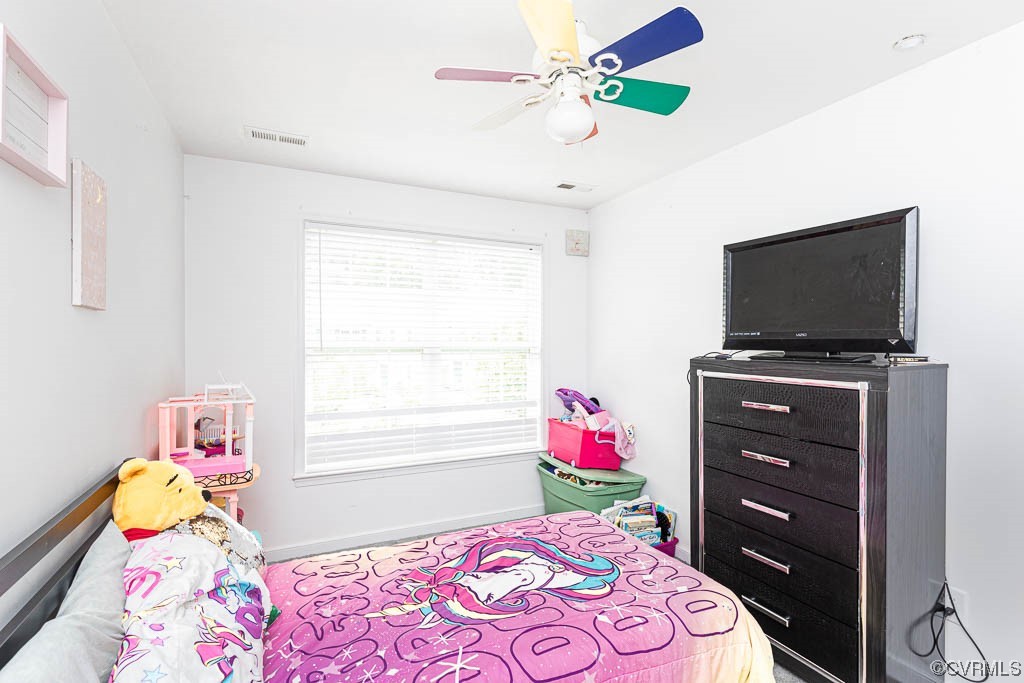 12124 Perdue Springs Loop Chester, VA 23831 - Photo 21 of 26 a bedroom with a bed a flat screen tv and a dresser