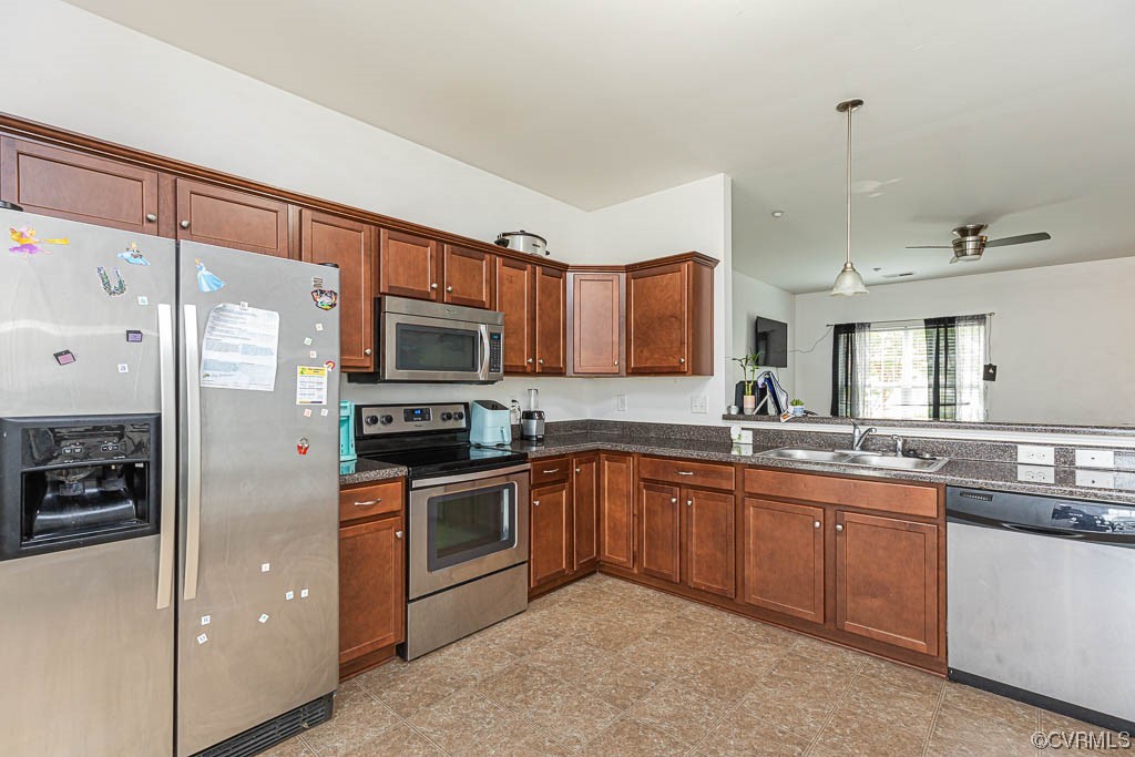 12124 Perdue Springs Loop Chester, VA 23831 - Photo 8 of 26 a kitchen with stainless steel appliances granite countertop a stove top oven a sink and a refrigerator