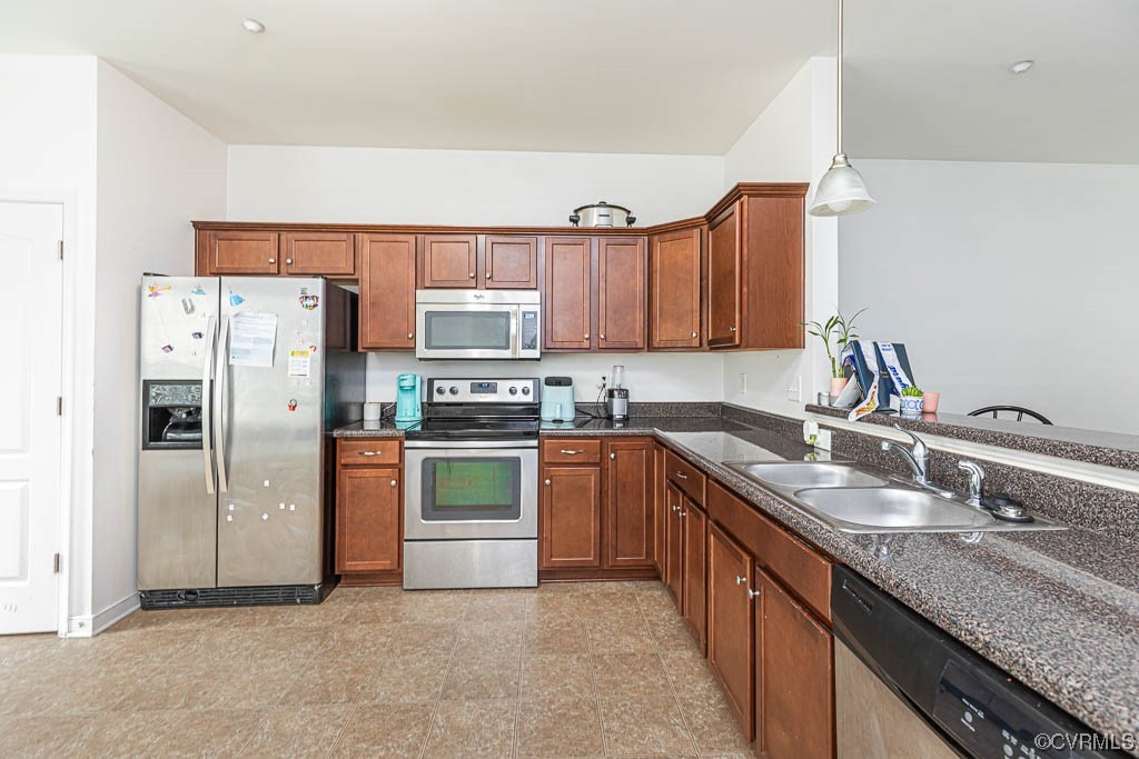 12124 Perdue Springs Loop Chester, VA 23831 - Photo 10 of 26 a kitchen with stainless steel appliances granite countertop a refrigerator sink and stove