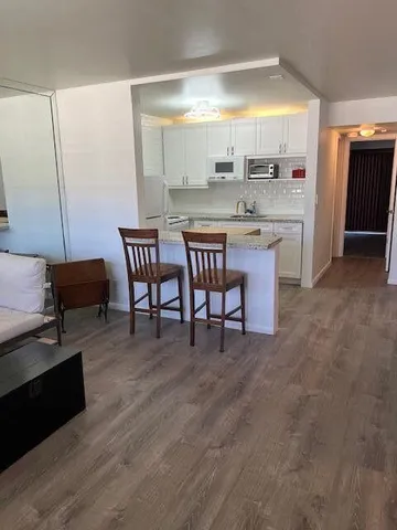 a large kitchen with a table and chairs