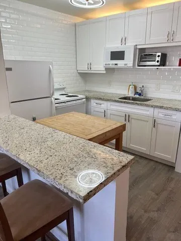 a kitchen with stainless steel appliances granite countertop a sink counter space and cabinets