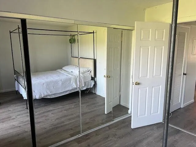 a bedroom with a bed and a mirror