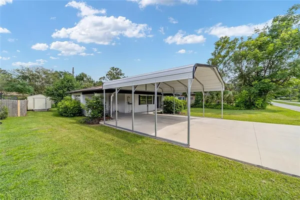 a view of a house with a backyard and a patio