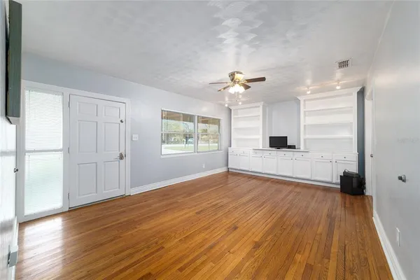 wooden floor in an empty room with a window