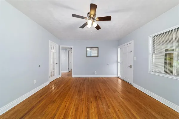wooden floor in an empty room with a window