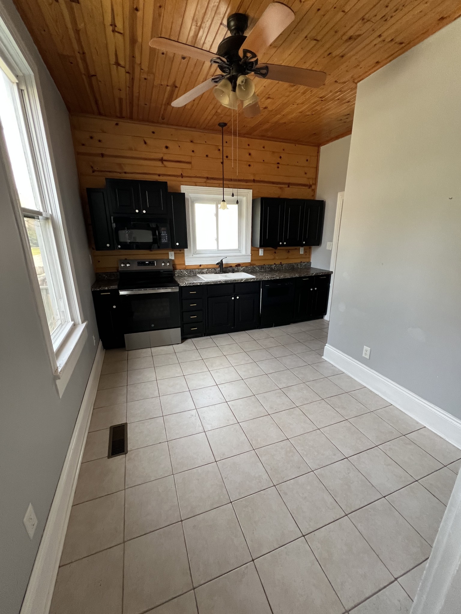 201 Pleasant Street Mount Pleasant, TN 38474 - Photo 11 of 38 a kitchen with granite countertop a sink and a counter top space