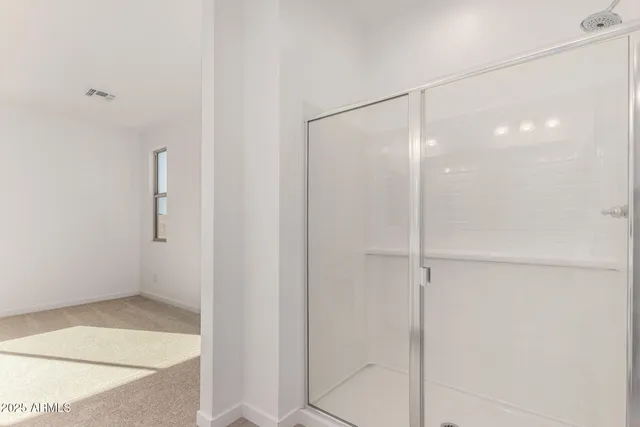 a bathroom with a glass shower door