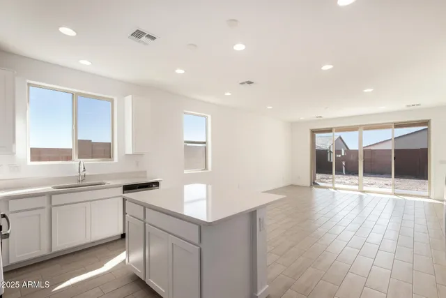 a kitchen with a sink and a stove top oven