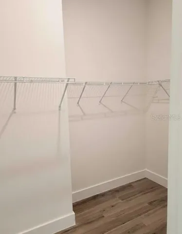 a view of a room with wooden floor