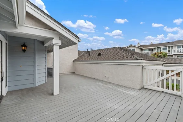 a view of a house with a wooden deck