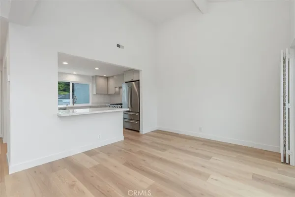 a large kitchen with granite countertop a large counter top stainless steel appliances and cabinets