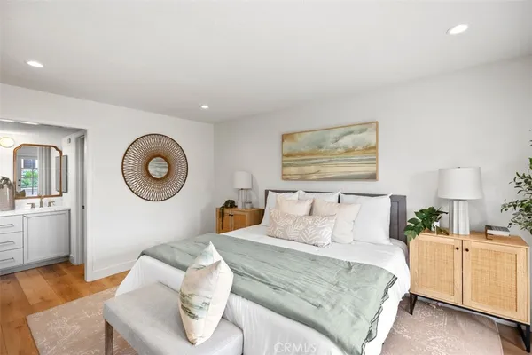 a bedroom with a bed and chandelier